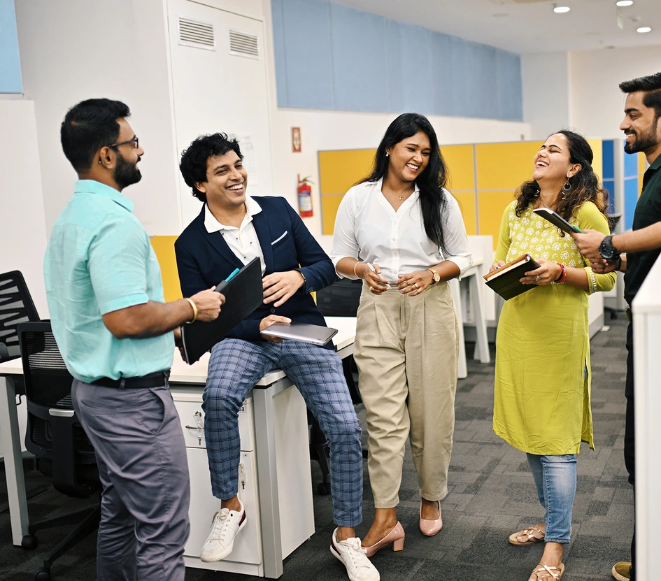Group of five business people in India discussion and laughing