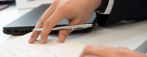 Men working on a document