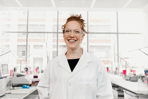 Smiling scientist in a lab wearing security glasses
