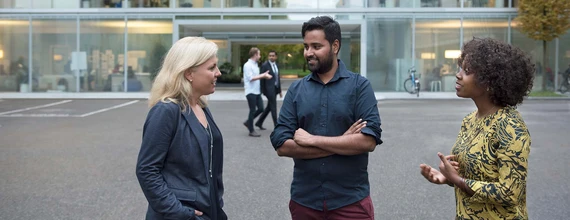 Three business people discussing on Novartis campus