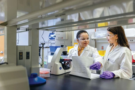 Two female scientist working in lab